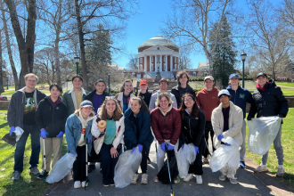 Students posing in front of the Rotunda after a Corner Cleanup