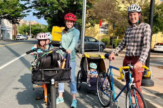 Bike Commuter families smiling for photo on Main Street