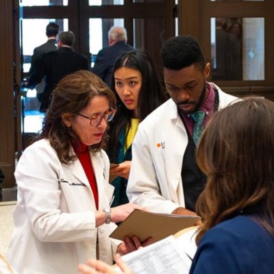 Dr Samantha Ahdoot speaking with others