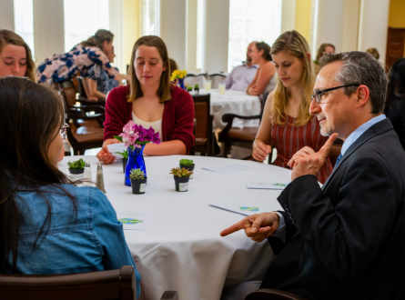 Professor talking at a table