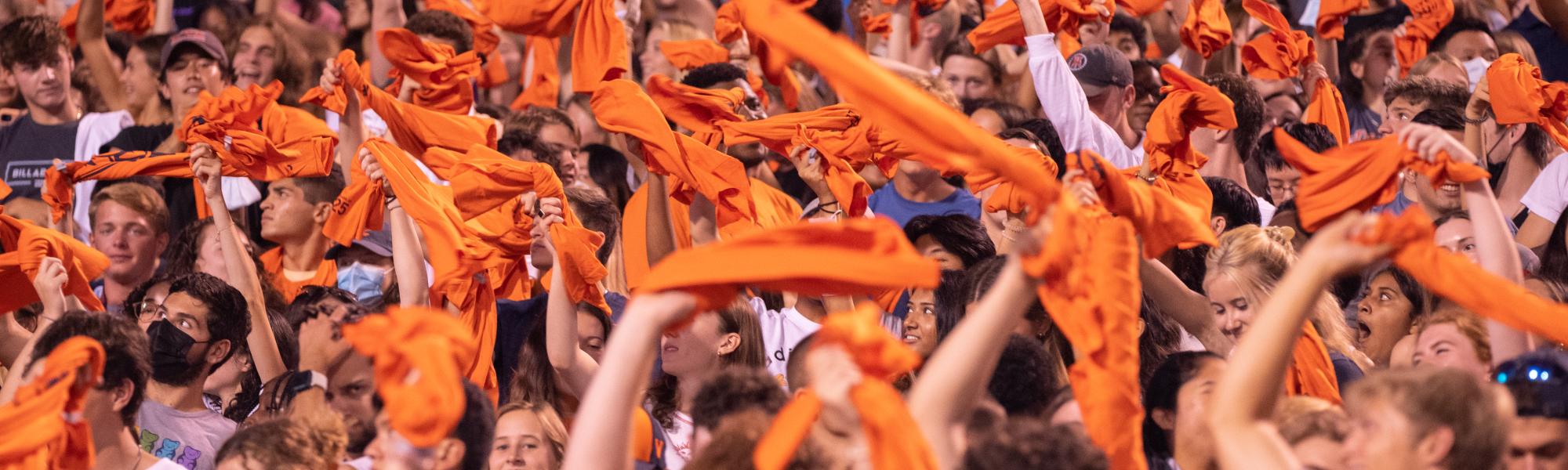 Fans at Scott Stadium waving orange towels.