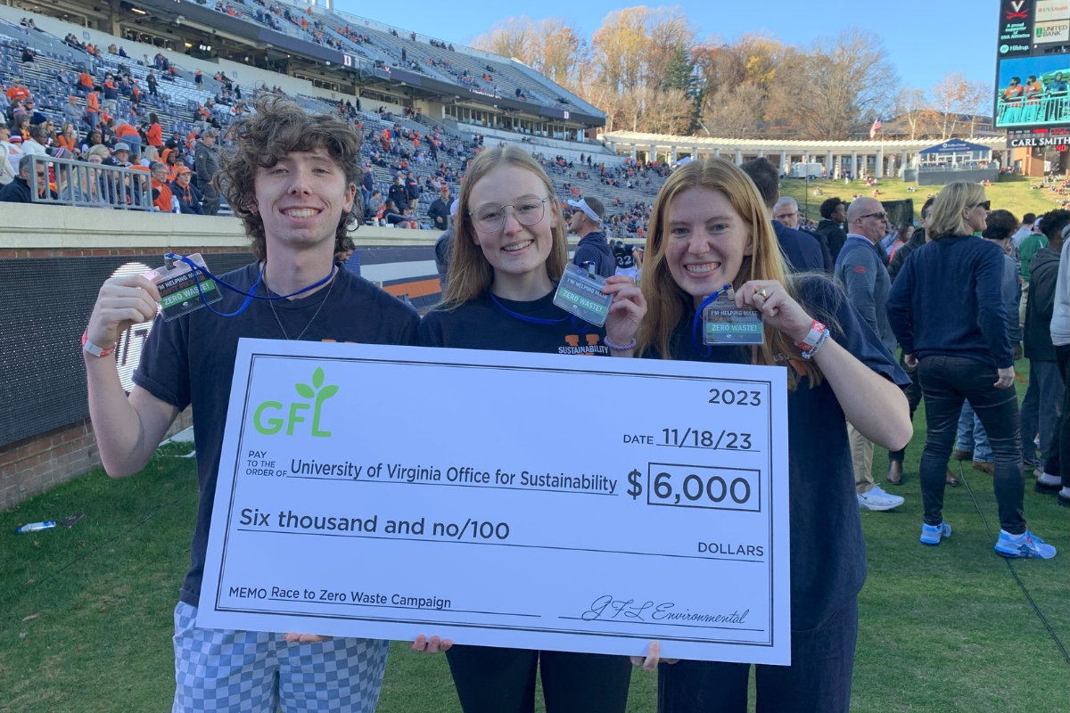Three sustainability student employees smiling and holding a check from GFL for $6,000