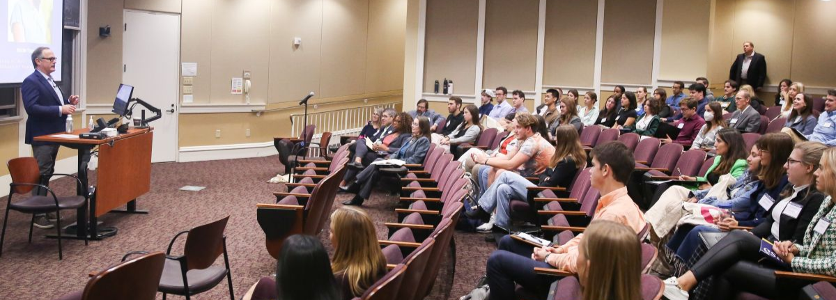 People in a lecture hall listening to speaker
