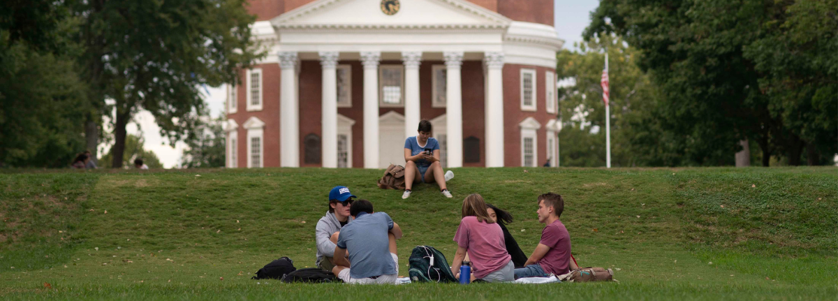 Students sitting on grass in front of Rotunda
