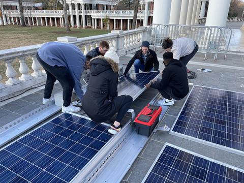 Student volunteers set up solar panels to help power the 2021 Lighting of the Lawn