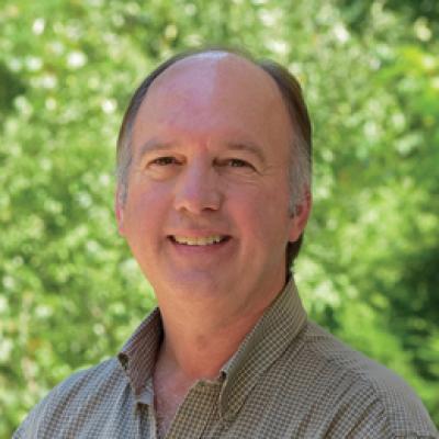 John Jones headshot with him smiling