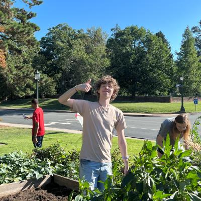 Photo of student employee giving thumbs up in UVA Student Garden.
